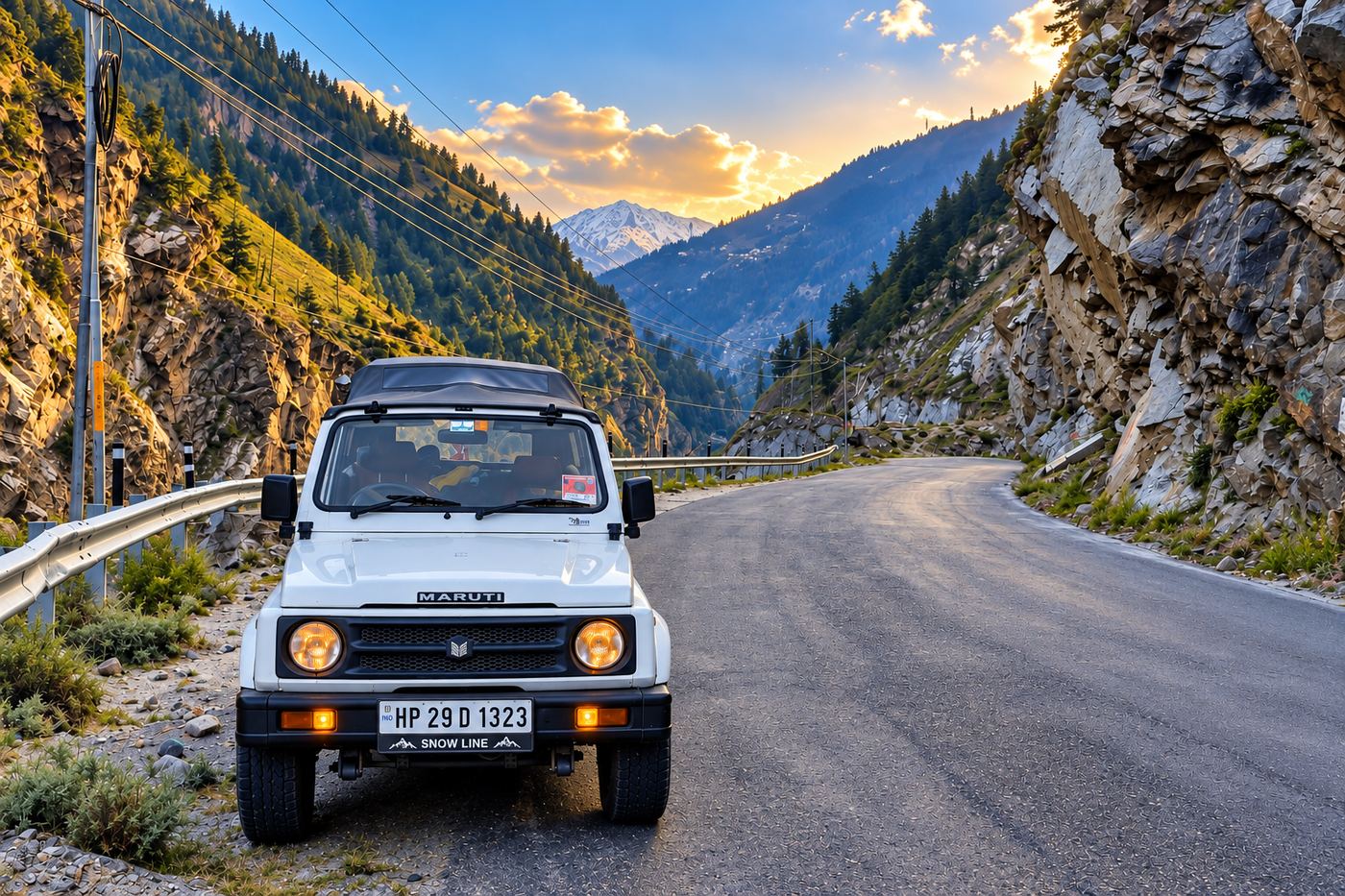 A Snowline Expedition vehicle parked on a mountain road above the Kullu valley at sunrise